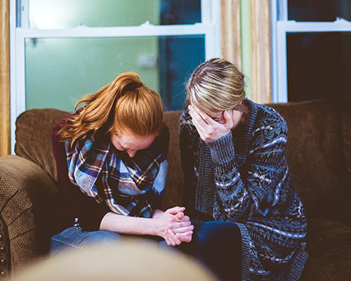 2 females in an emotional conversation